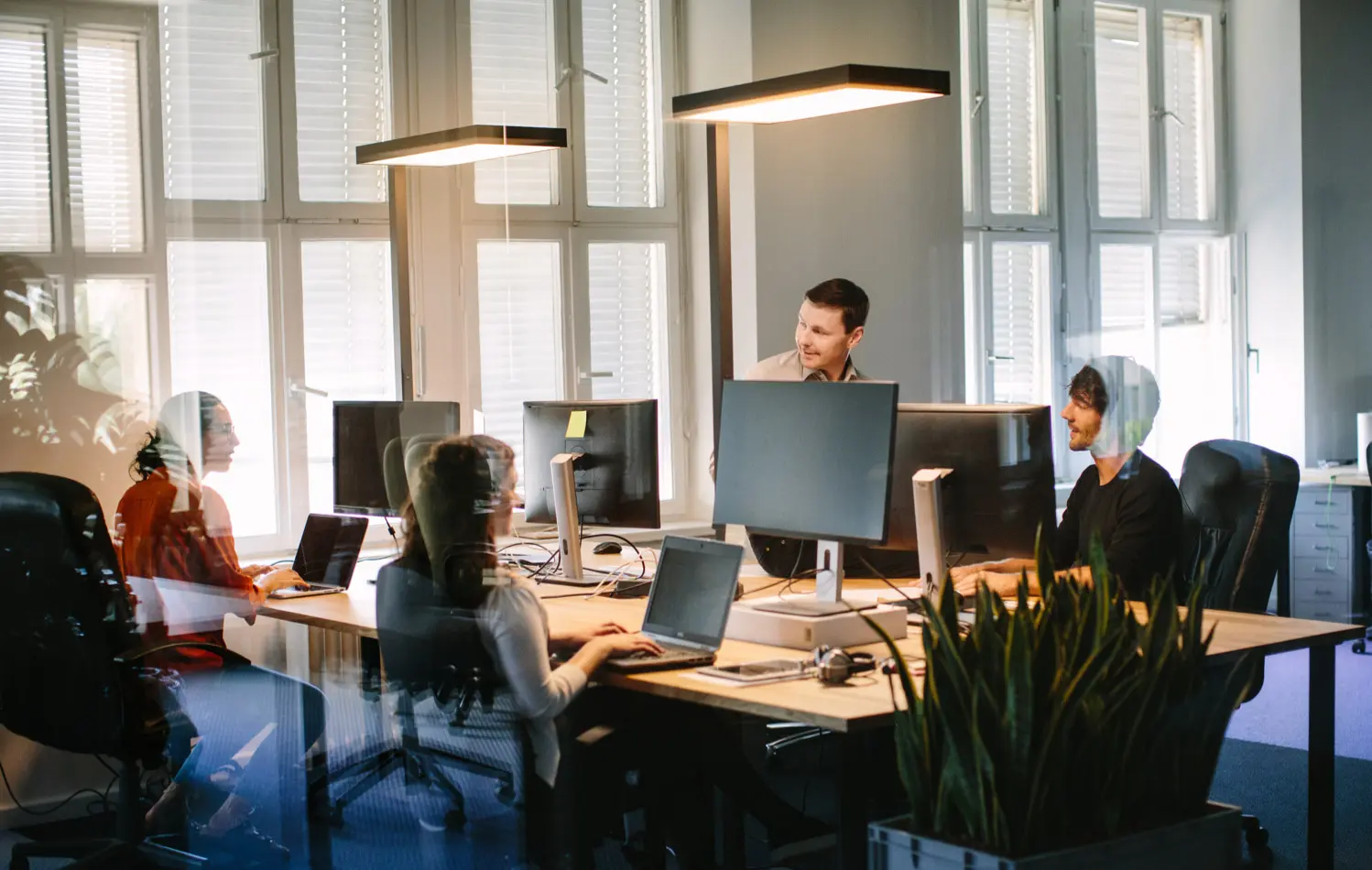 Office environment with people working on computers